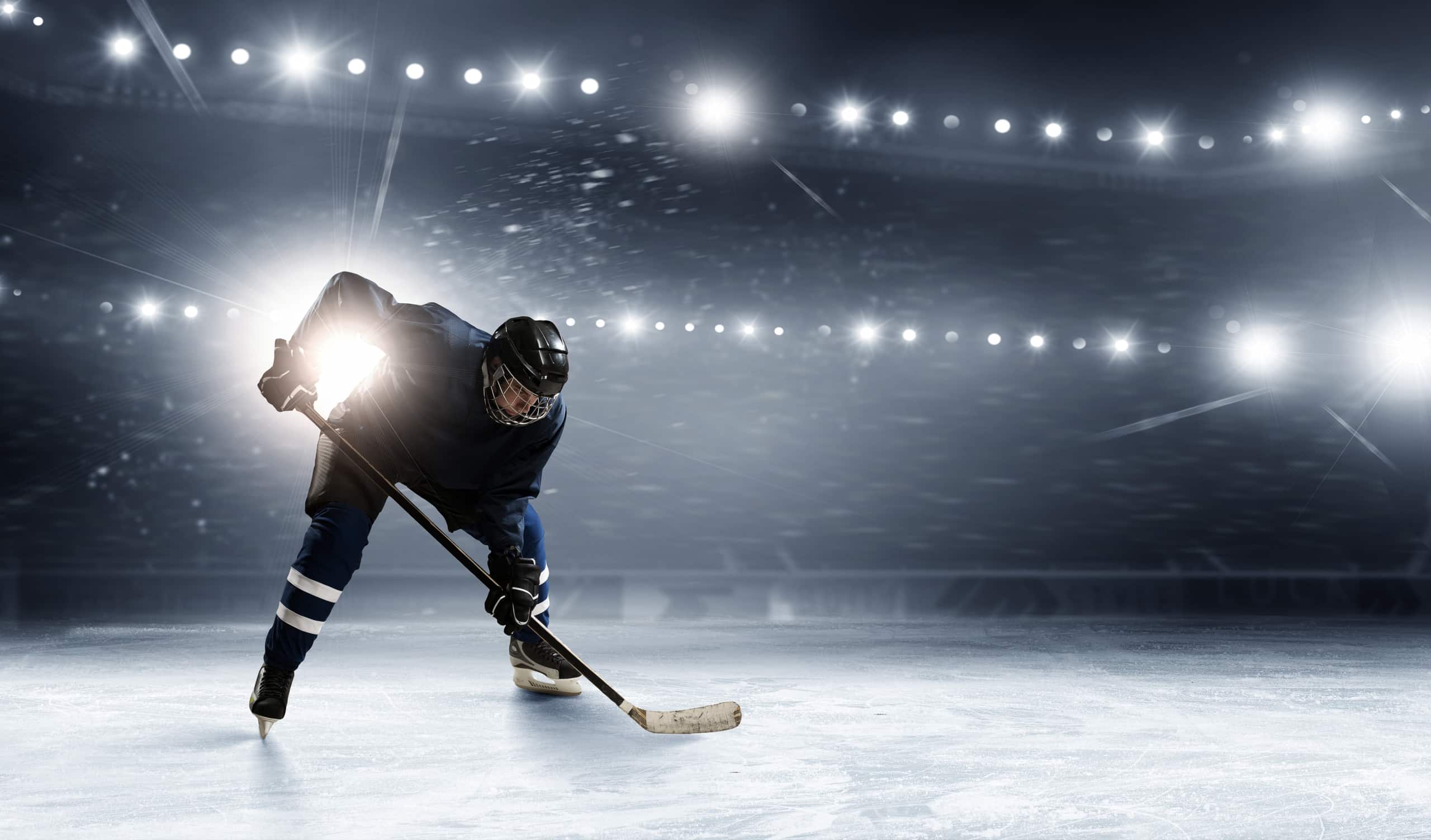 Hockey player in lights at ice rink