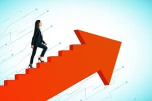 business woman walking up stairs resembling an arrow pointed upwards to illustrate her succeeding due to boosting self-awareness