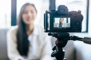 Woman recording herself for a remote virtual interview