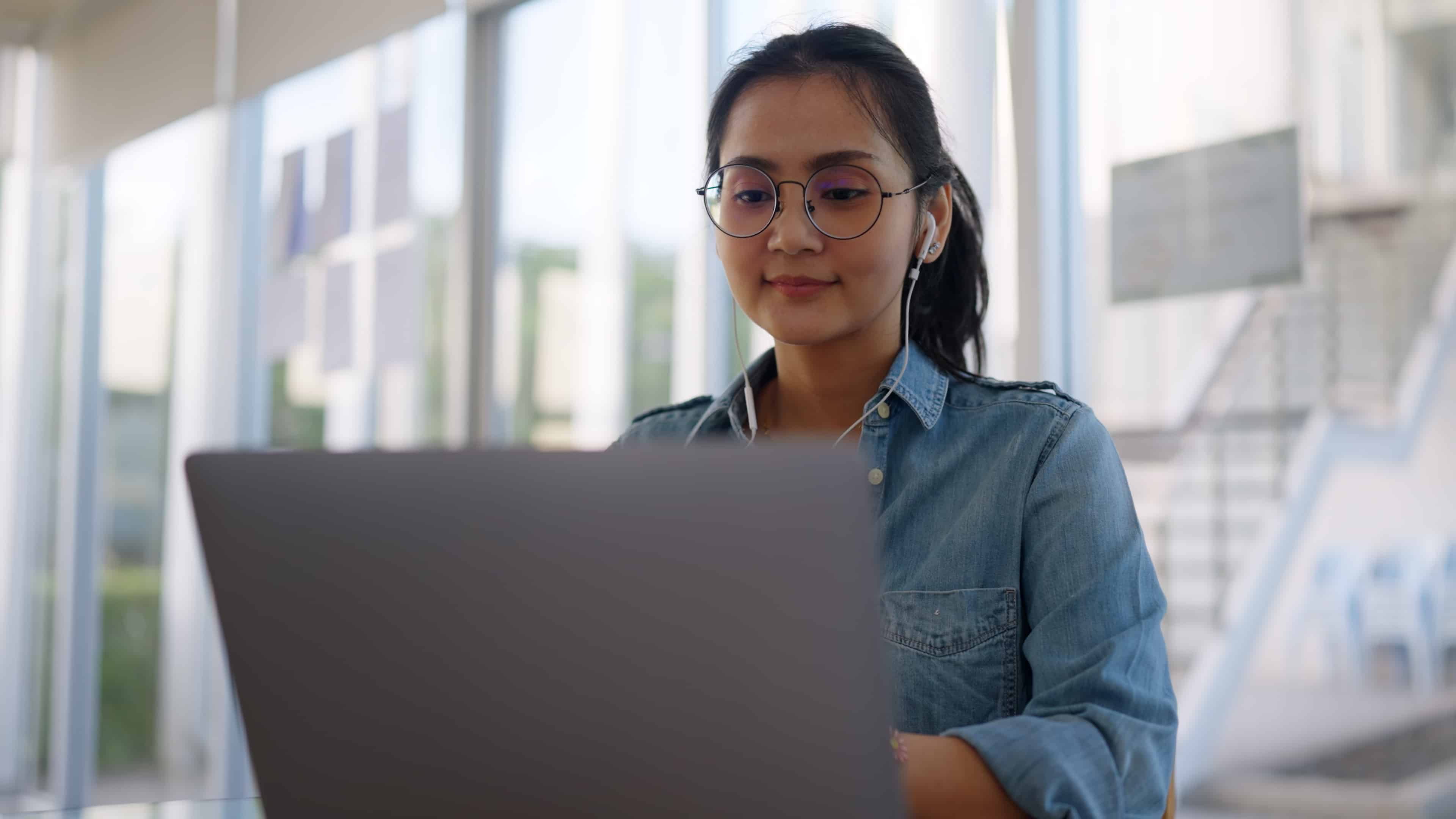 university student working on laptop in office