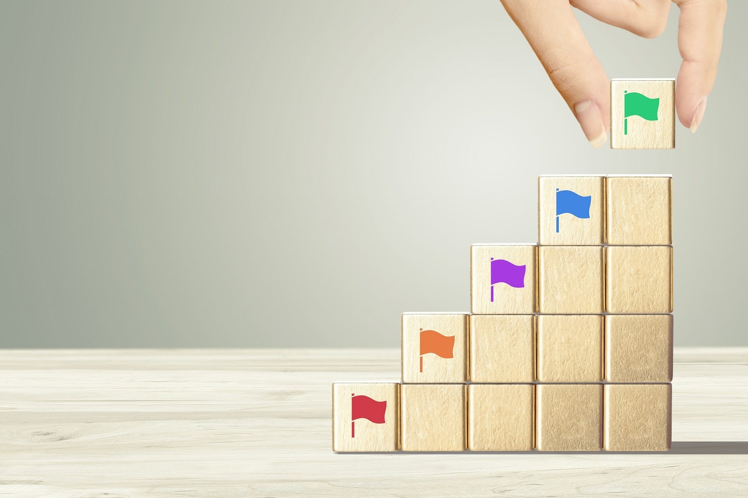 stack of wooden blocks with coloured flags