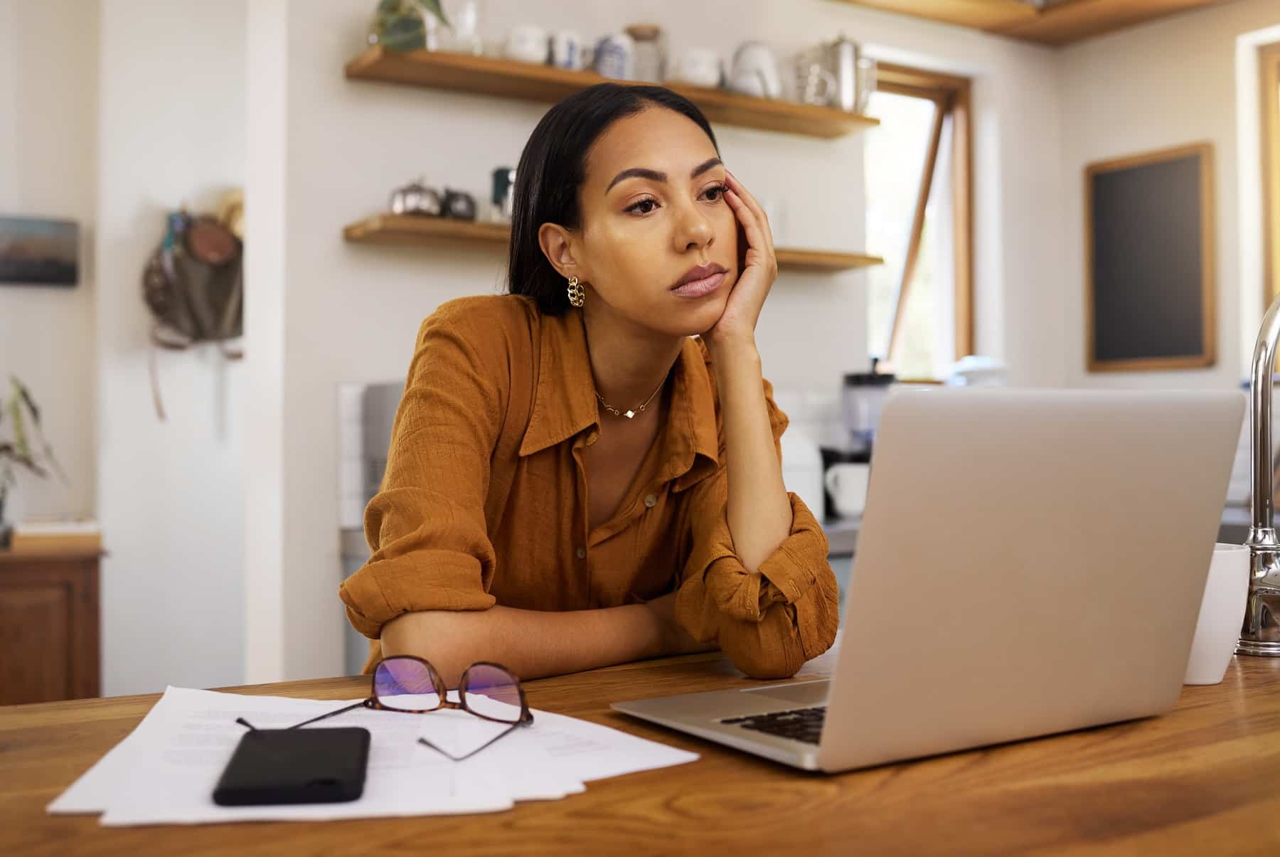 Tired woman working remotely on laptop burnout, fatigue, brain fog