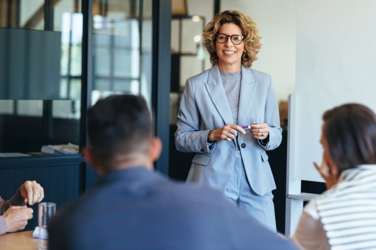 Woman standing in office leading team through change