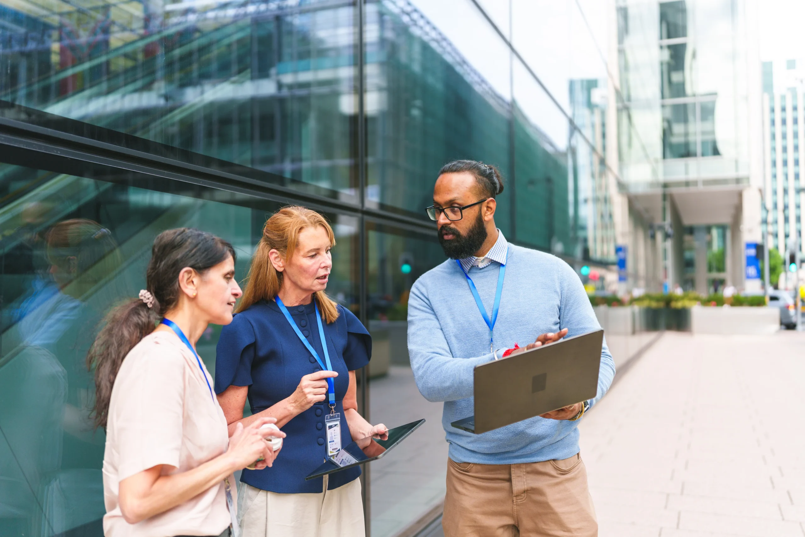 Team_Leaders_Discussing_Change_Outside_Office_Building_Laptop