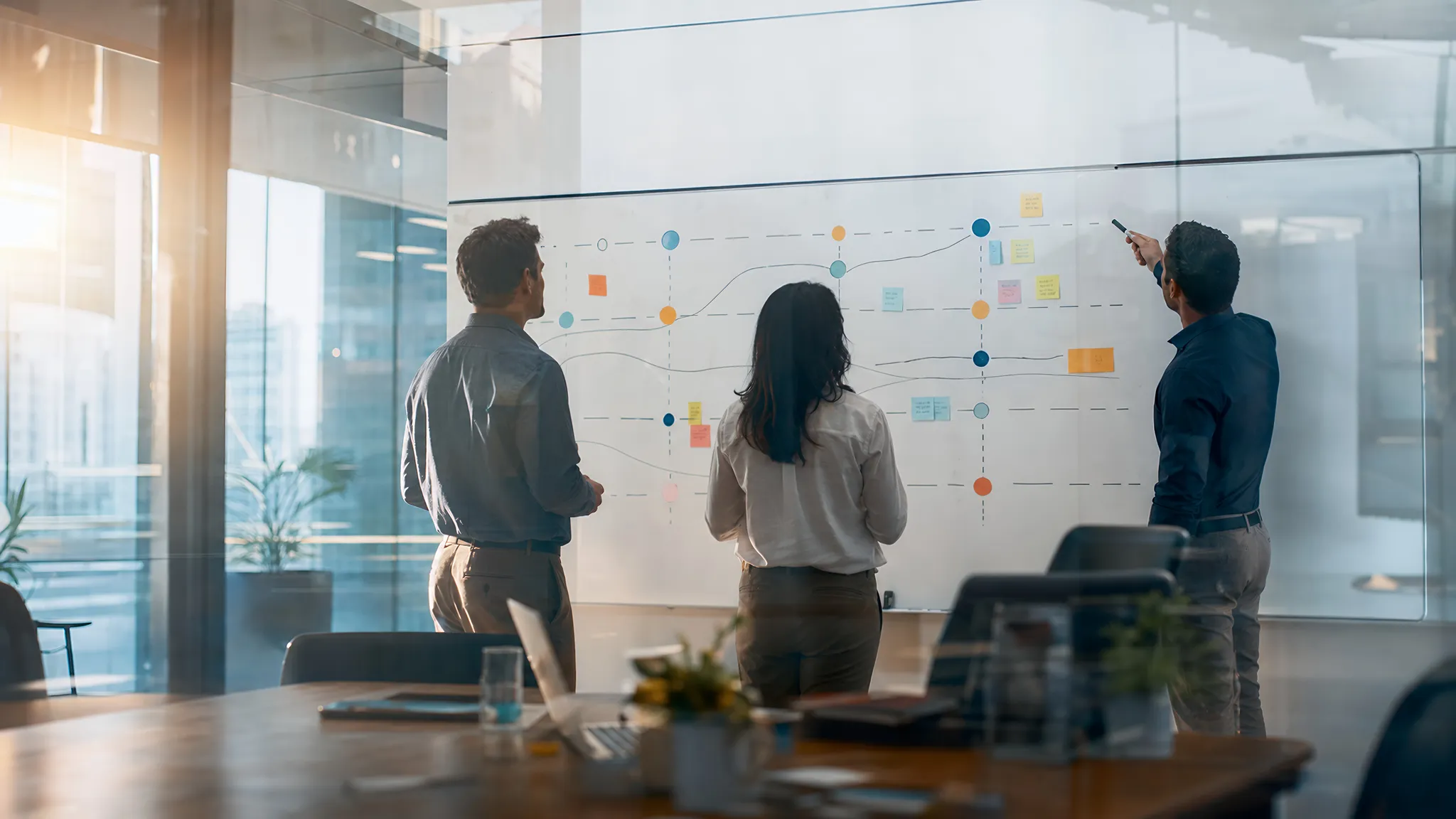 hr leaders looking at leadership pipeline on whiteboard in office